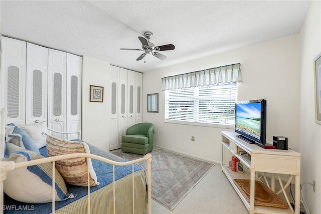 interior space featuring ceiling fan, light colored carpet, and a textured ceiling