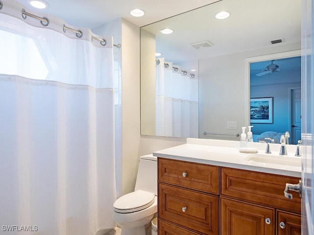 7425 Pelican Bay Blvd Unit 301, Naples, FL 34108 - bathroom with vanity, ceiling fan, and toilet