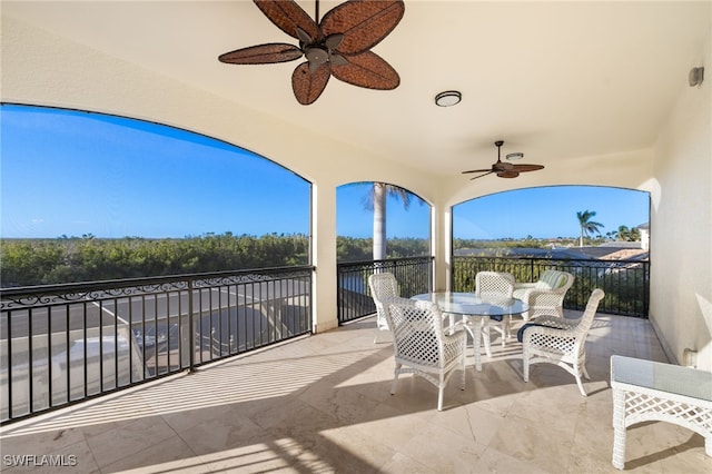 view of patio / terrace with a balcony and ceiling fan