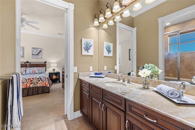 bathroom with crown molding, tile patterned floors, vanity, and ceiling fan