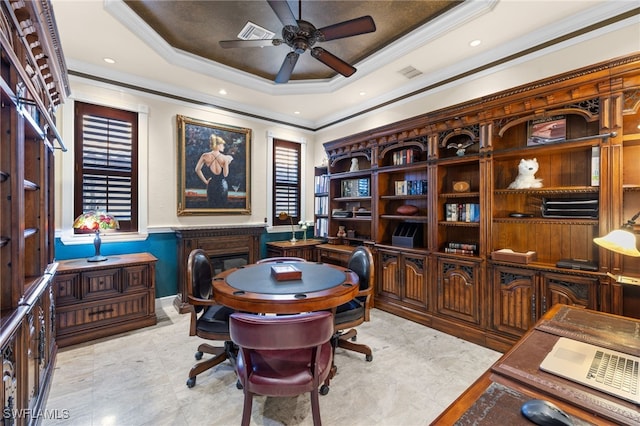 home office with a raised ceiling, crown molding, and ceiling fan