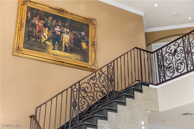 stairs featuring crown molding