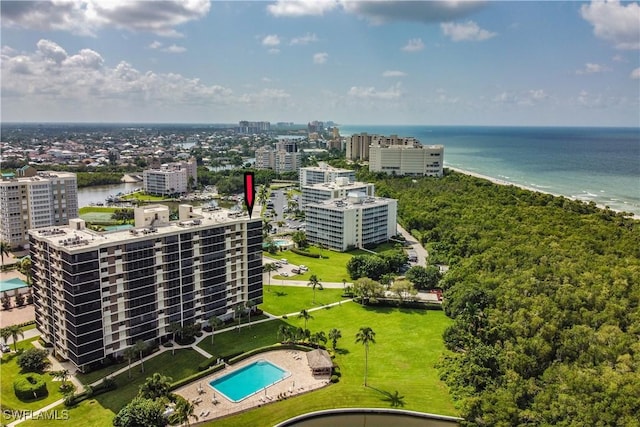 drone / aerial view with a water view and a beach view