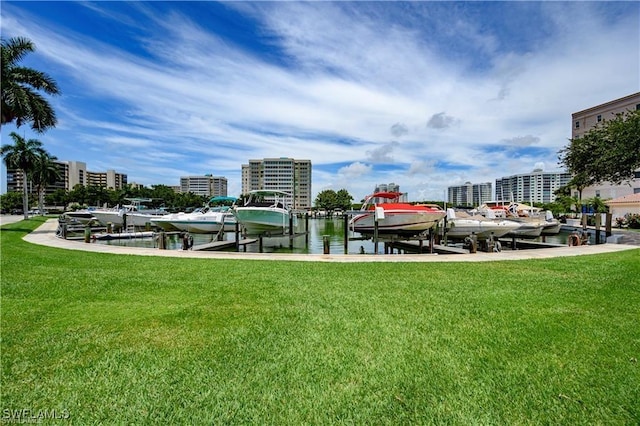 view of property's community with a water view, a lawn, and a boat dock