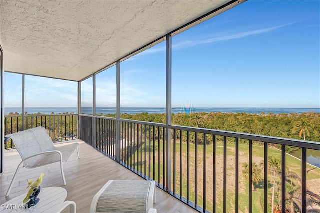 sunroom / solarium with a water view