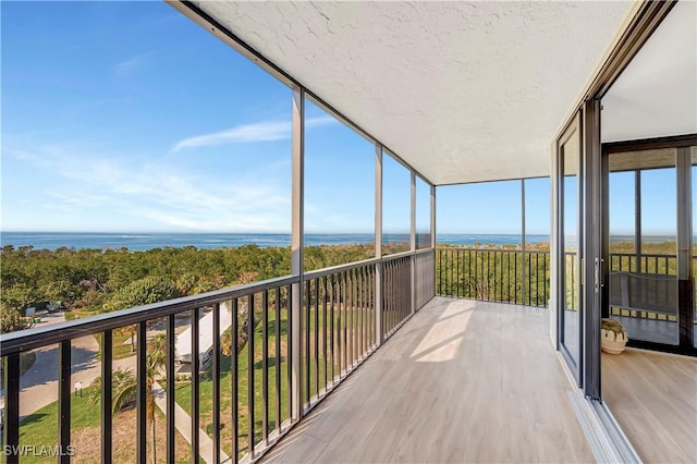 sunroom / solarium with a water view