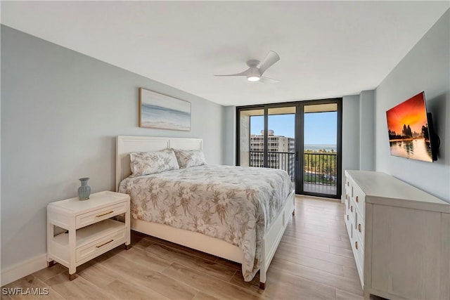 bedroom with ceiling fan, light wood-type flooring, access to exterior, and a wall of windows