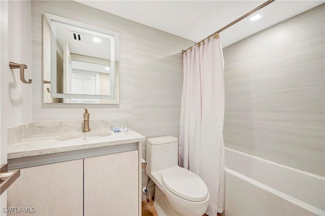 full bathroom with shower / bathtub combination with curtain, vanity, and toilet