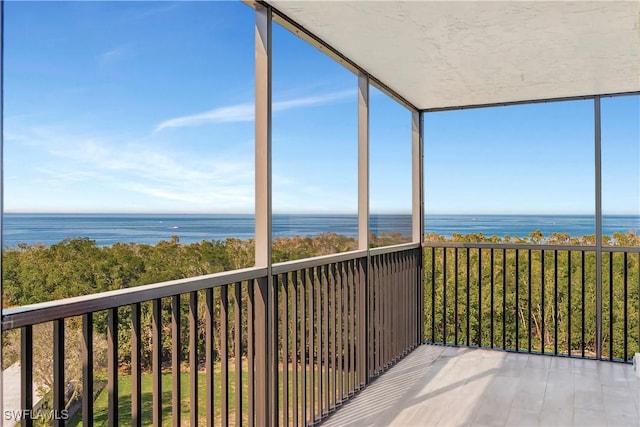 unfurnished sunroom with a water view