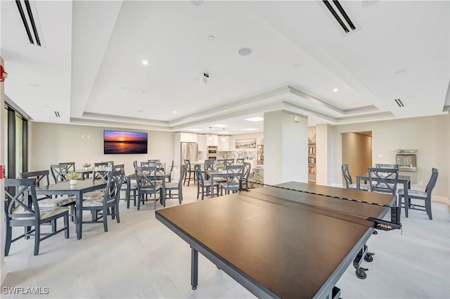 game room featuring a tray ceiling