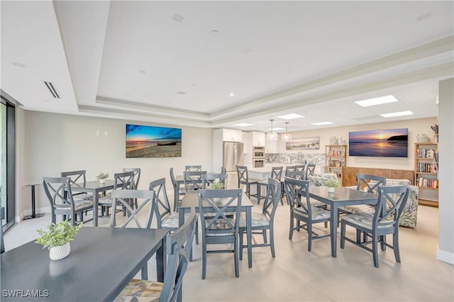 dining area featuring a raised ceiling