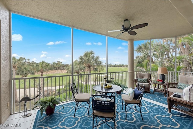 sunroom featuring ceiling fan and a healthy amount of sunlight