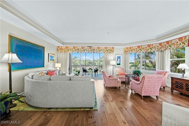 living room featuring hardwood / wood-style flooring and crown molding