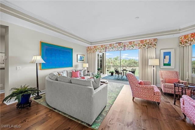 living room with crown molding and hardwood / wood-style floors