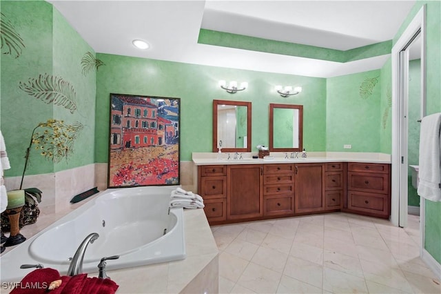 bathroom with vanity and a relaxing tiled tub