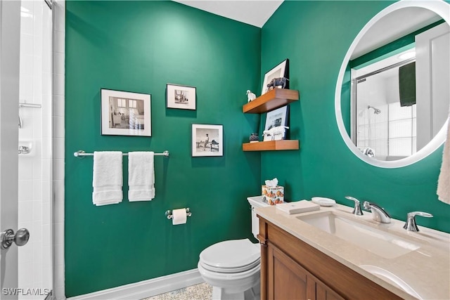 bathroom featuring toilet, walk in shower, and vanity