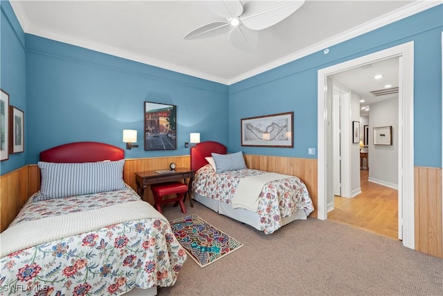 carpeted bedroom with crown molding and ceiling fan