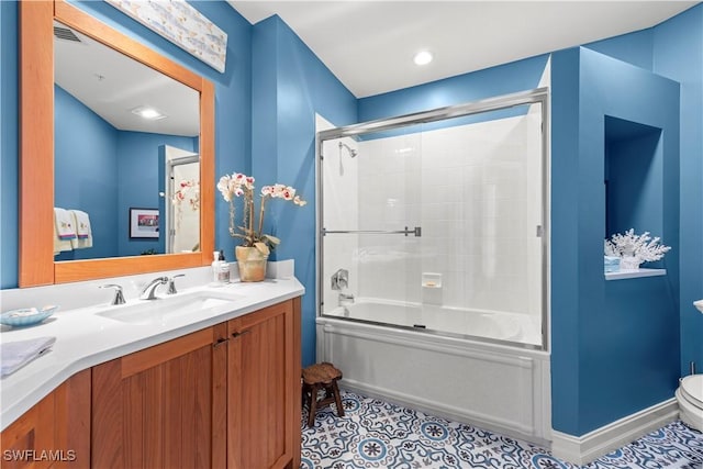 full bathroom featuring bath / shower combo with glass door, toilet, vanity, and tile patterned flooring