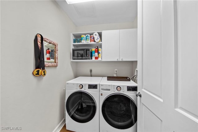 laundry area with cabinets and independent washer and dryer