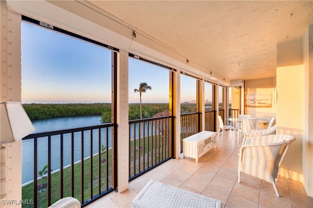 sunroom / solarium with a water view