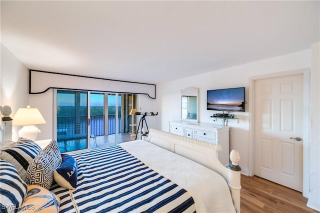 bedroom with access to outside and light hardwood / wood-style floors