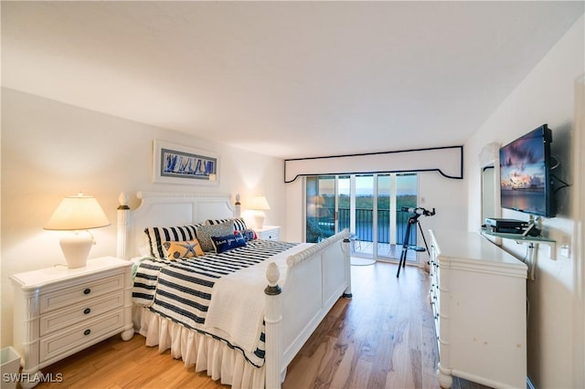 bedroom featuring access to exterior and light hardwood / wood-style floors