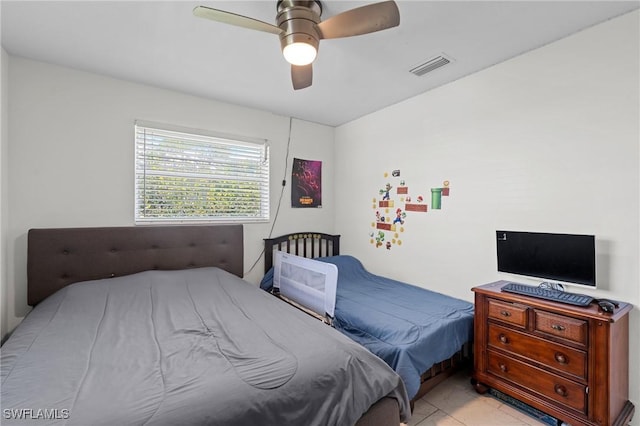 bedroom with ceiling fan, visible vents, and light tile patterned flooring