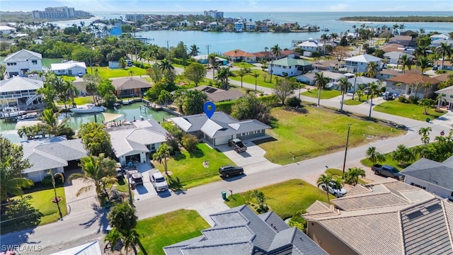 drone / aerial view featuring a residential view and a water view