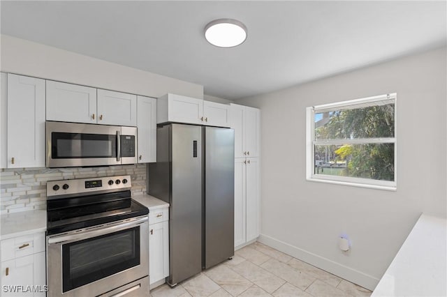 kitchen featuring decorative backsplash, white cabinetry, appliances with stainless steel finishes, and light countertops