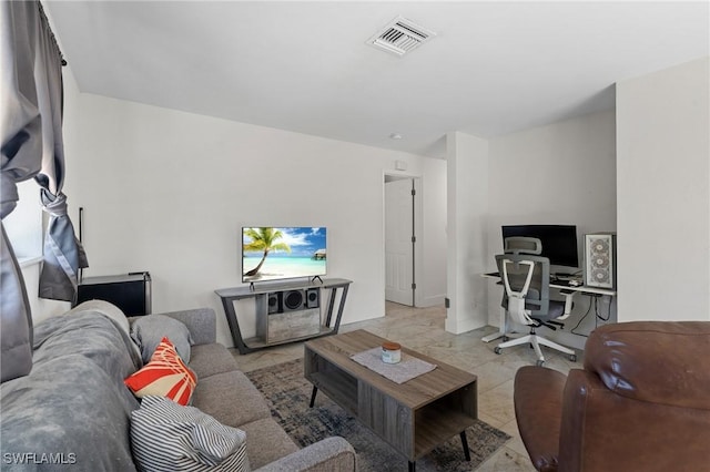 tiled living area with visible vents and baseboards