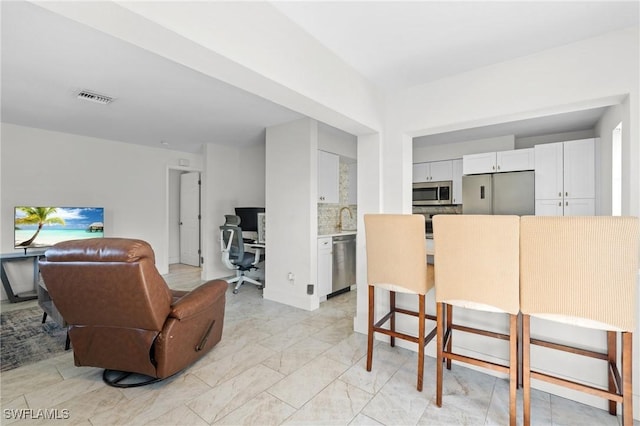 living room with visible vents and marble finish floor