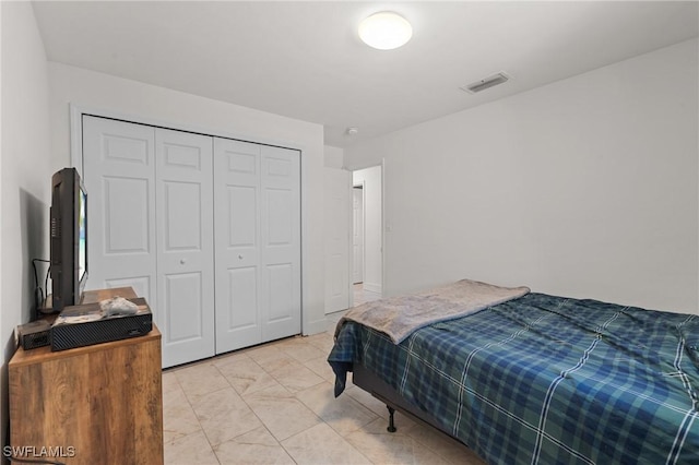 bedroom featuring visible vents and a closet