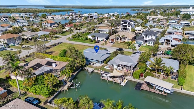 birds eye view of property featuring a residential view and a water view