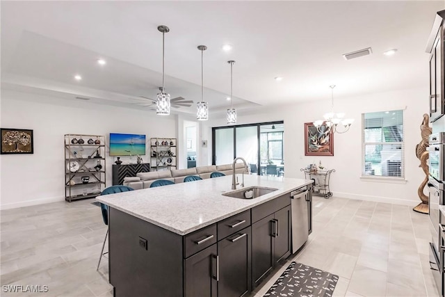 kitchen featuring recessed lighting, ceiling fan with notable chandelier, stainless steel dishwasher, a sink, and visible vents