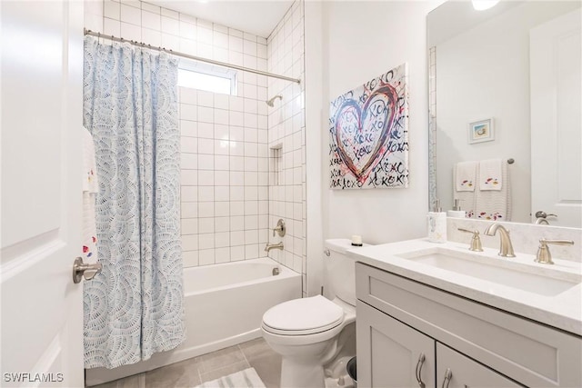 bathroom featuring tile patterned floors, toilet, vanity, and shower / bath combo with shower curtain