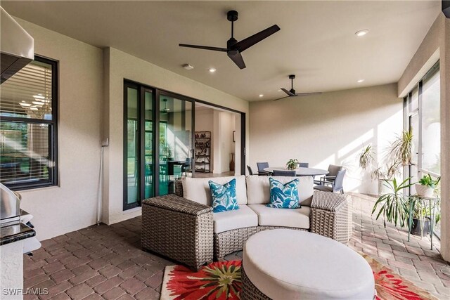 view of patio with an outdoor living space, outdoor dining area, and a ceiling fan