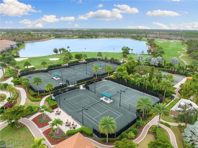 drone / aerial view with golf course view and a water view