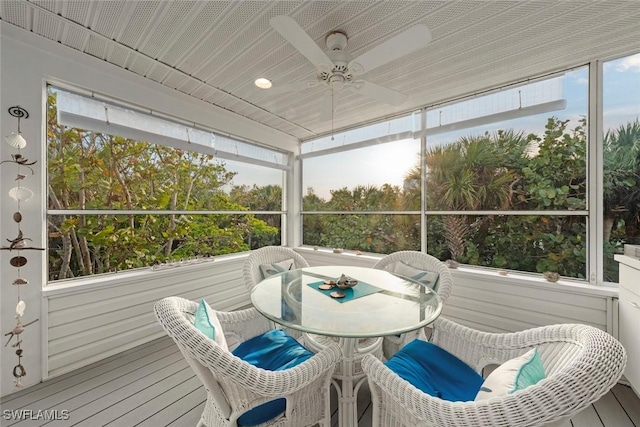 sunroom / solarium featuring plenty of natural light and ceiling fan