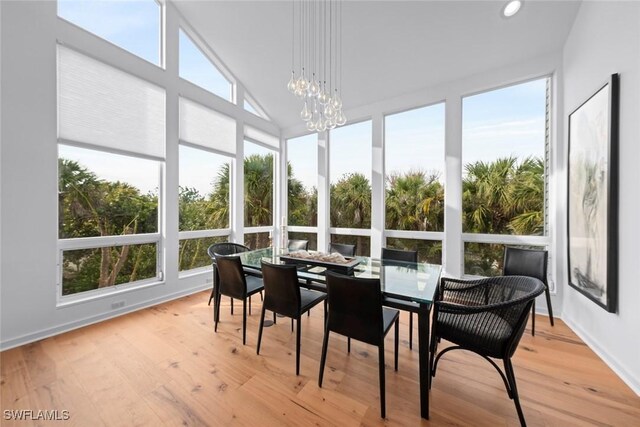 sunroom / solarium featuring a notable chandelier