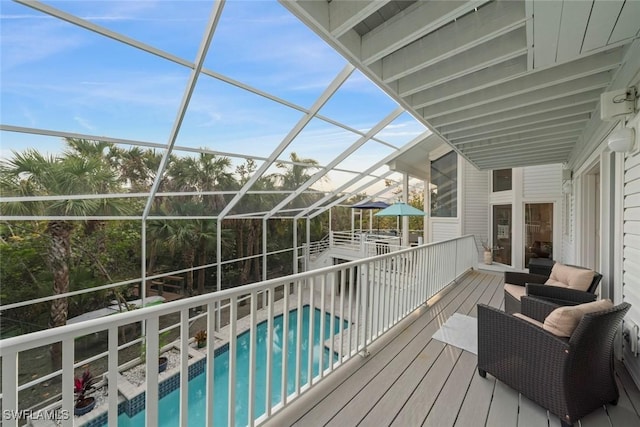 wooden terrace featuring a patio and glass enclosure