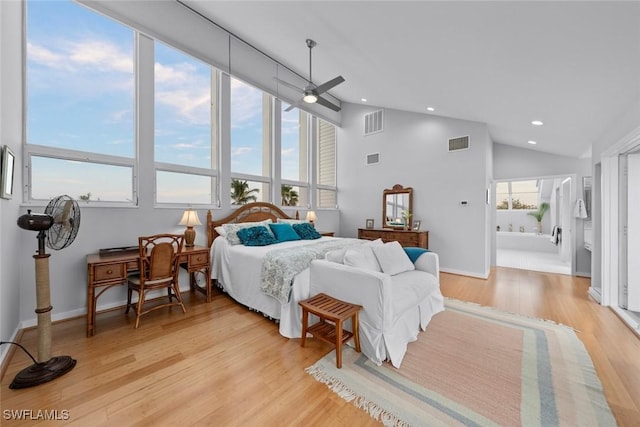 bedroom with ensuite bath, high vaulted ceiling, ceiling fan, and light wood-type flooring