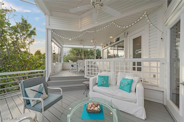 sunroom featuring ceiling fan