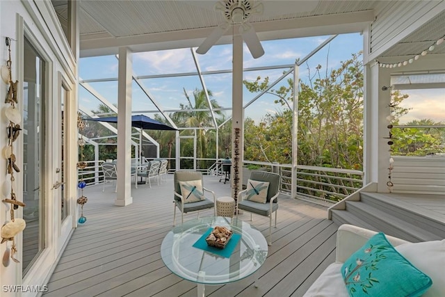 unfurnished sunroom featuring ceiling fan