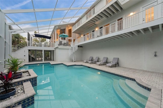 view of pool featuring a patio and glass enclosure