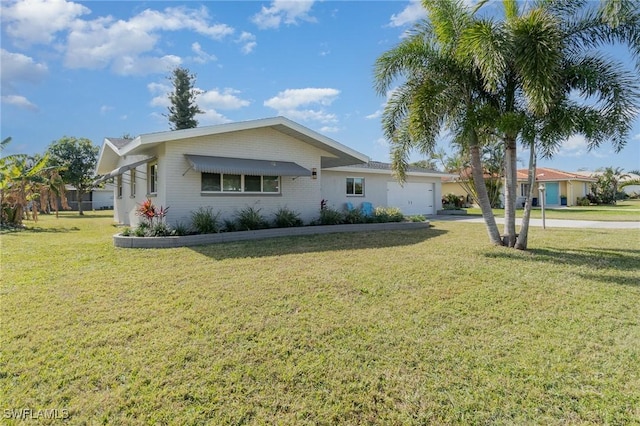 single story home featuring a garage and a front lawn