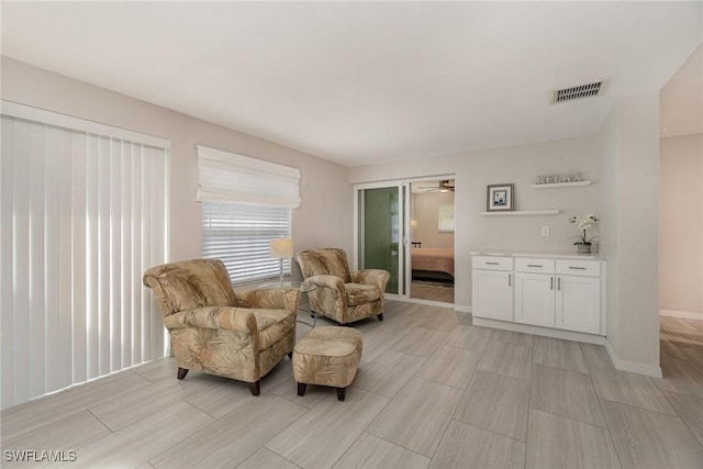 sitting room featuring ceiling fan