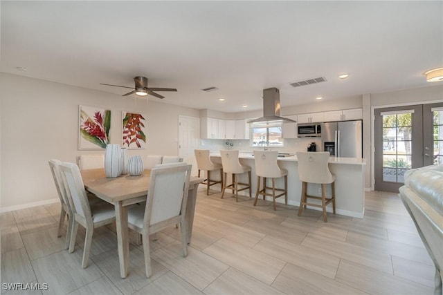 dining space featuring a wealth of natural light, french doors, and ceiling fan