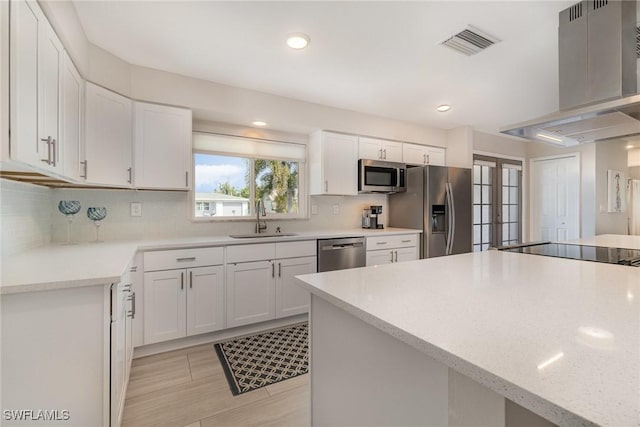 kitchen with french doors, sink, extractor fan, stainless steel appliances, and white cabinets