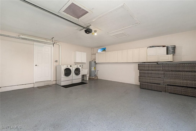 garage featuring a garage door opener, washer and clothes dryer, and electric water heater