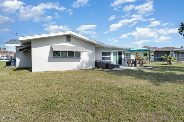 rear view of property featuring a patio area and a lawn